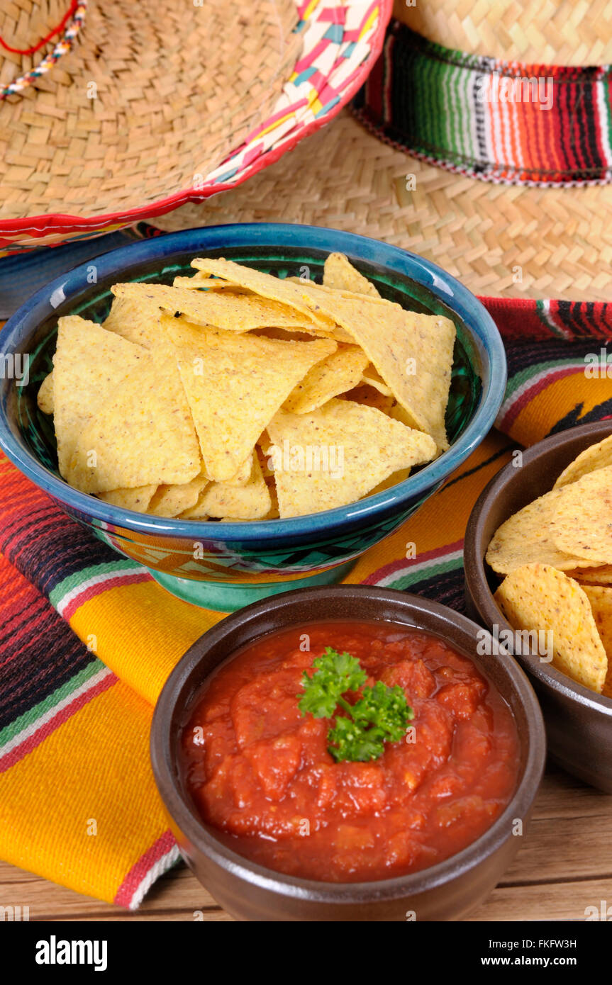 Mexican sombreros and traditional serape blankets with salsa dip and