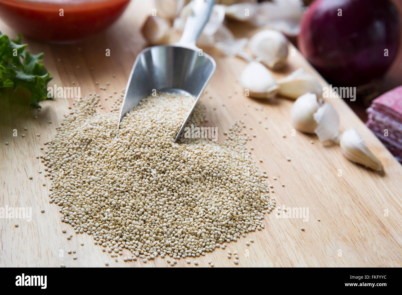 Scoop of quinoa surrounded by ingredients to make vegan Sloppy Joes. Stock Photo