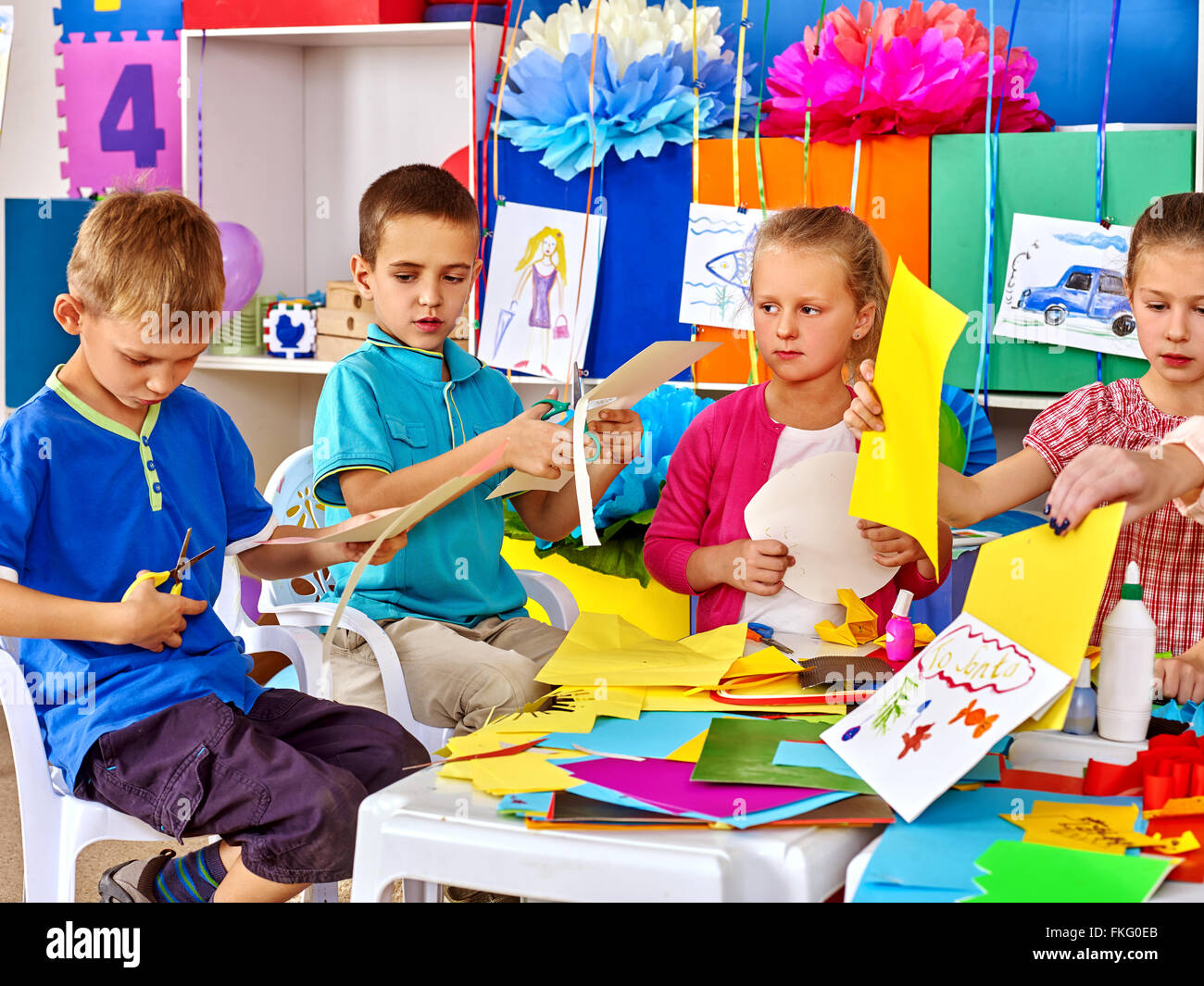 Group kids make applique of colored paper in kindergarten Stock Photo ...