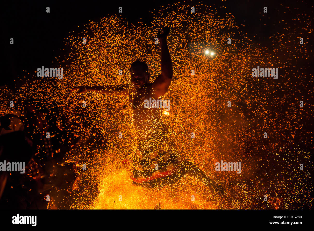 Bali, Indonesia. 08th Mar, 2016. A Balinese man runs through the fire during the 'Mesabatan Api' ritual a head of Nyepi Day on March, 2016 at Banjar Nagi in Gianyar, Bali, Indonesia. Mesabatan Api is held annually a day before the Nyepi Day of Silence, as symbolizes the purification of universe and human body trough fire. Nyepi is a Hindu celebration observed every new year according to the Balinese calendar. Credit:  Agung Parameswara/Alamy Live News Stock Photo