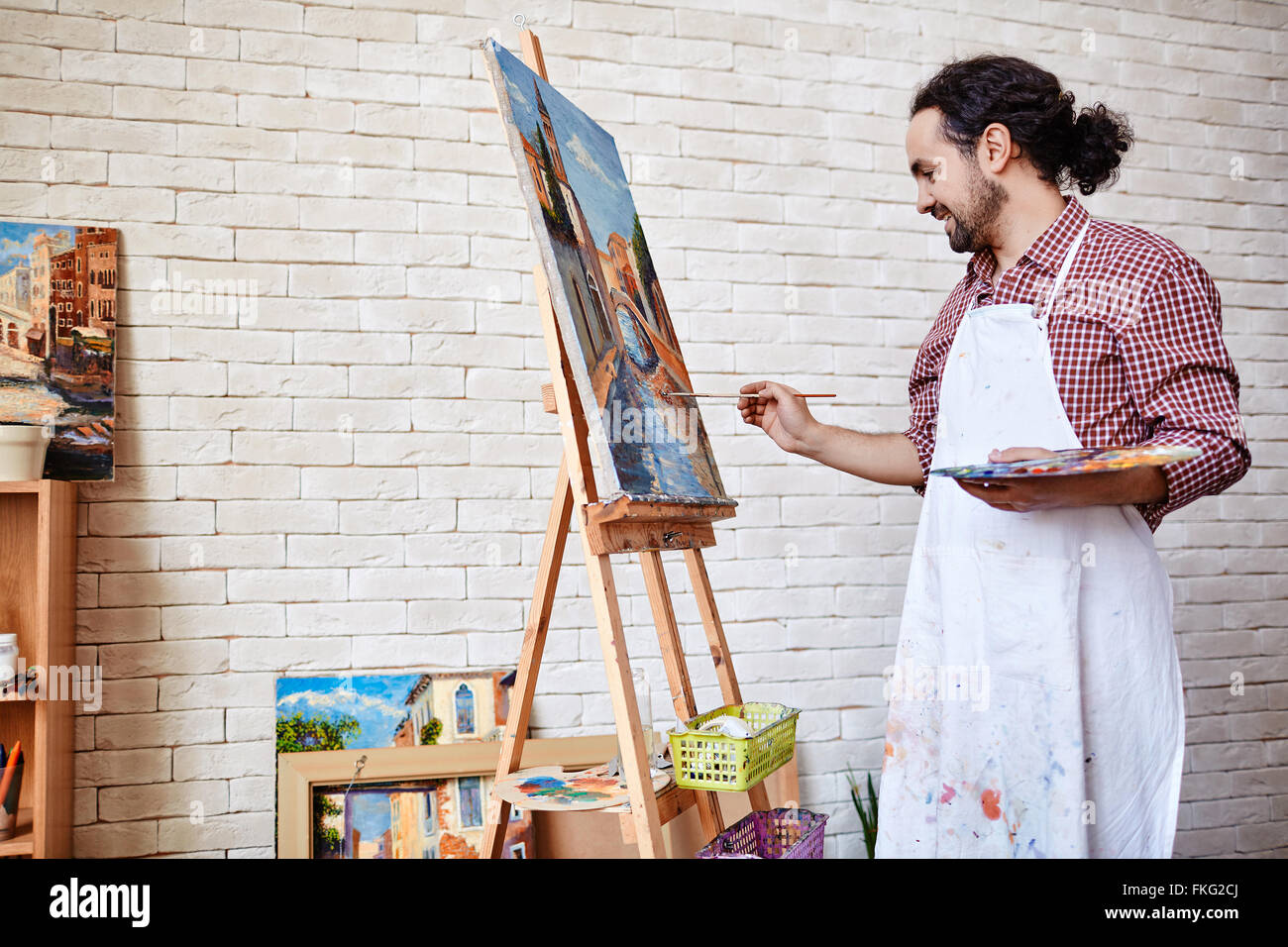 Professional artist painting a picture on canvas Stock Photo Alamy