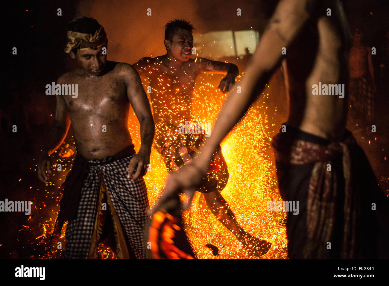 Bali, Indonesia. 08th Mar, 2016. A Balinese man kicks the fire during the 'Mesabatan Api' ritual a head of Nyepi Day on March, 2016 at Banjar Nagi in Gianyar, Bali, Indonesia. Mesabatan Api is held annually a day before the Nyepi Day of Silence, as symbolizes the purification of universe and human body trough fire. Nyepi is a Hindu celebration observed every new year according to the Balinese calendar. Credit:  Agung Parameswara/Alamy Live News Stock Photo