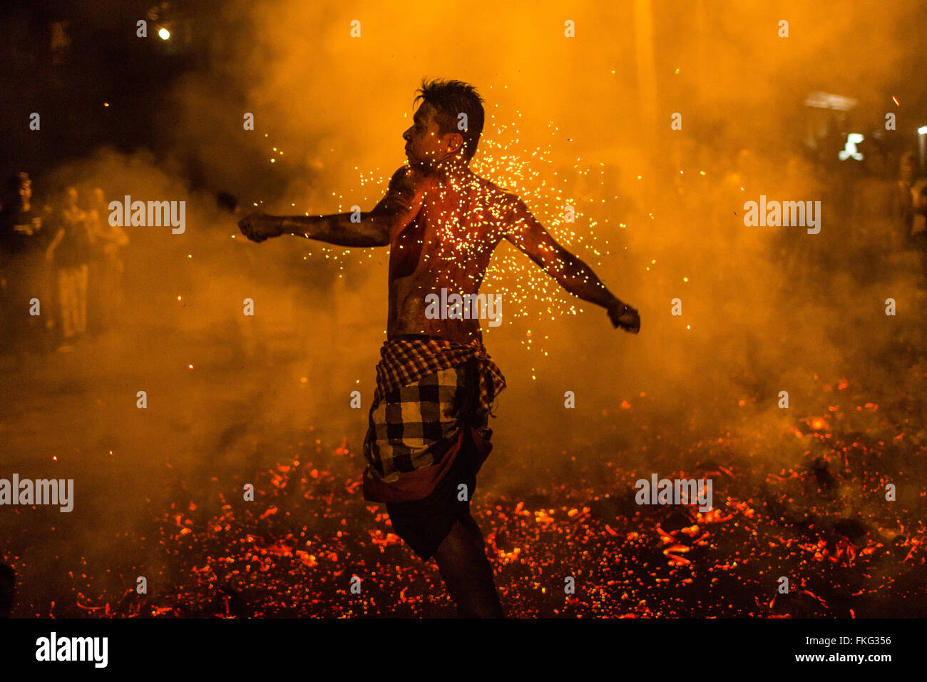 Bali, Indonesia. 08th Mar, 2016. A Balinese man gestures as he prepare to throw the fire during the 'Mesabatan Api' ritual a head of Nyepi Day on March, 2016 at Banjar Nagi in Gianyar, Bali, Indonesia. Mesabatan Api is held annually a day before the Nyepi Day of Silence, as symbolizes the purification of universe and human body trough fire. Nyepi is a Hindu celebration observed every new year according to the Balinese calendar. Credit:  Agung Parameswara/Alamy Live News Stock Photo