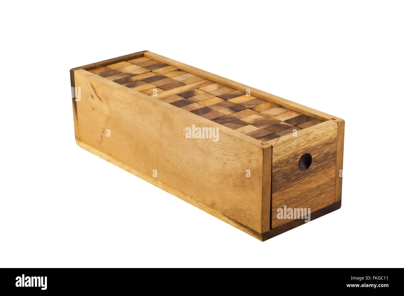 Wooden puzzle blocks in wooden box isolated on white background. Stock Photo