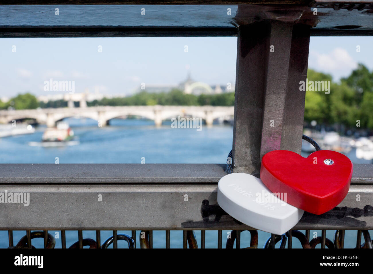 Red and white love locks on bridge in Paris Stock Photo