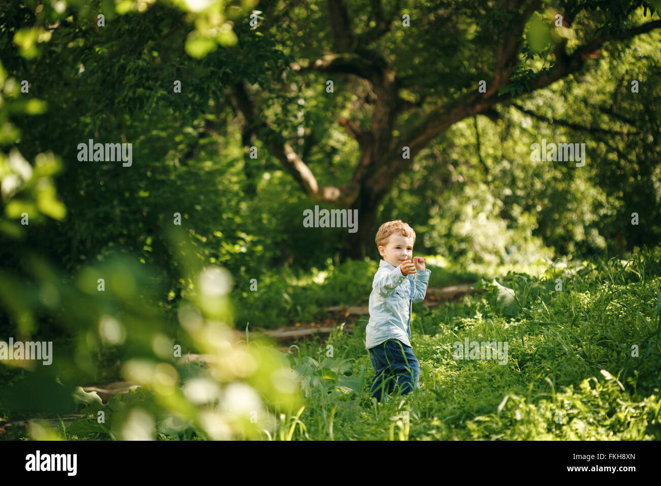 Happy Childhood. Cute Little Boy Having Fun in the Summer Park Outdoors