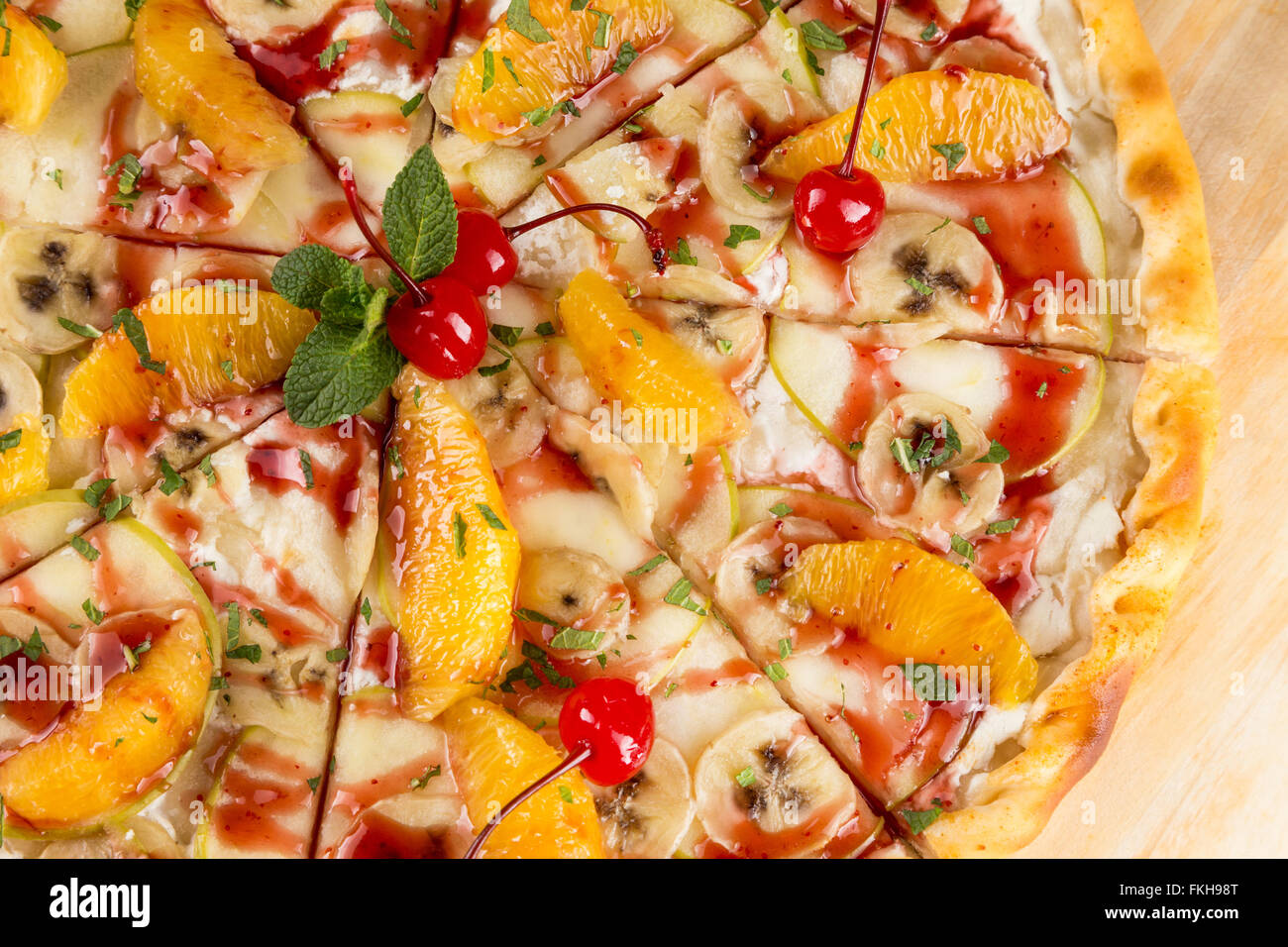 closeup dessert food the sweet pizza with orange, banana, apple and cherry Stock Photo