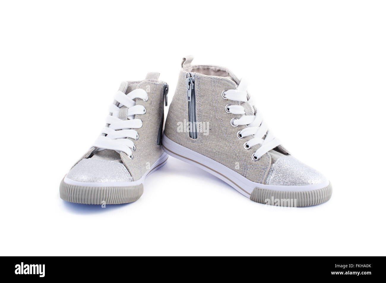 Beige jeans sneakers with white laces isolated on white Stock Photo