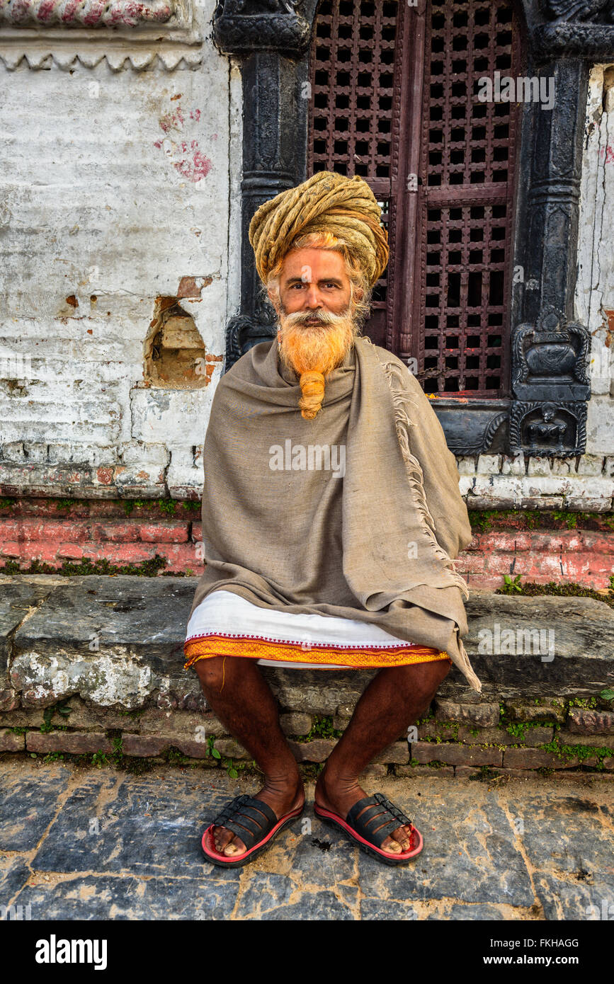 Wandering  sadhu baba (holy man) with traditional long hair in ancient Pashupatinath Temple Stock Photo