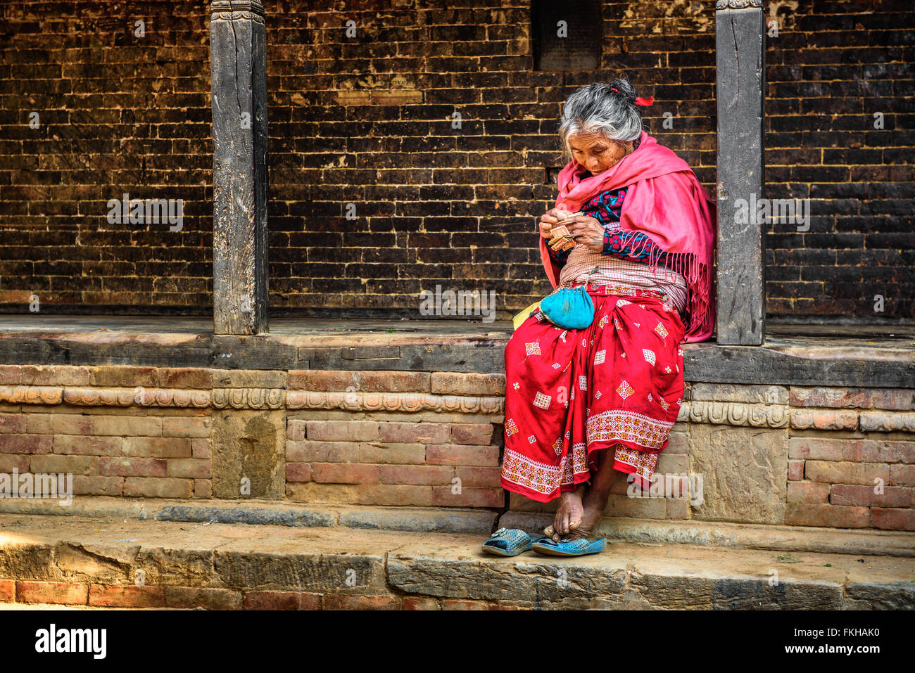 Old woman begs in the street of Bandipur Stock Photo
