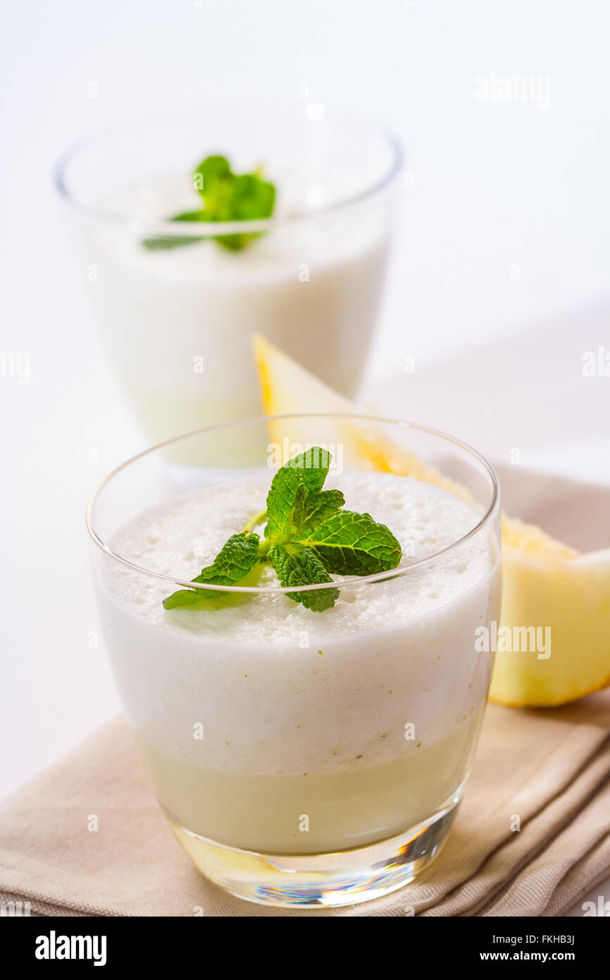 A fresh melon and mint smoothie, topped with mint leaves. Stock Photo