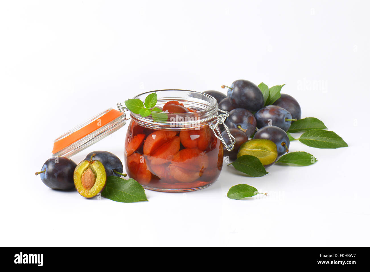 fresh and preserved plums on white background Stock Photo Alamy