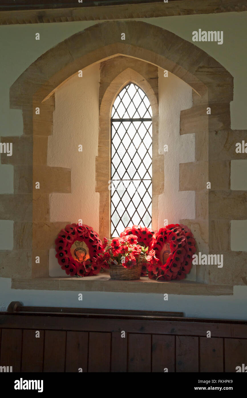 The Royal British Legion red poppy wreaths in window of St Mary's