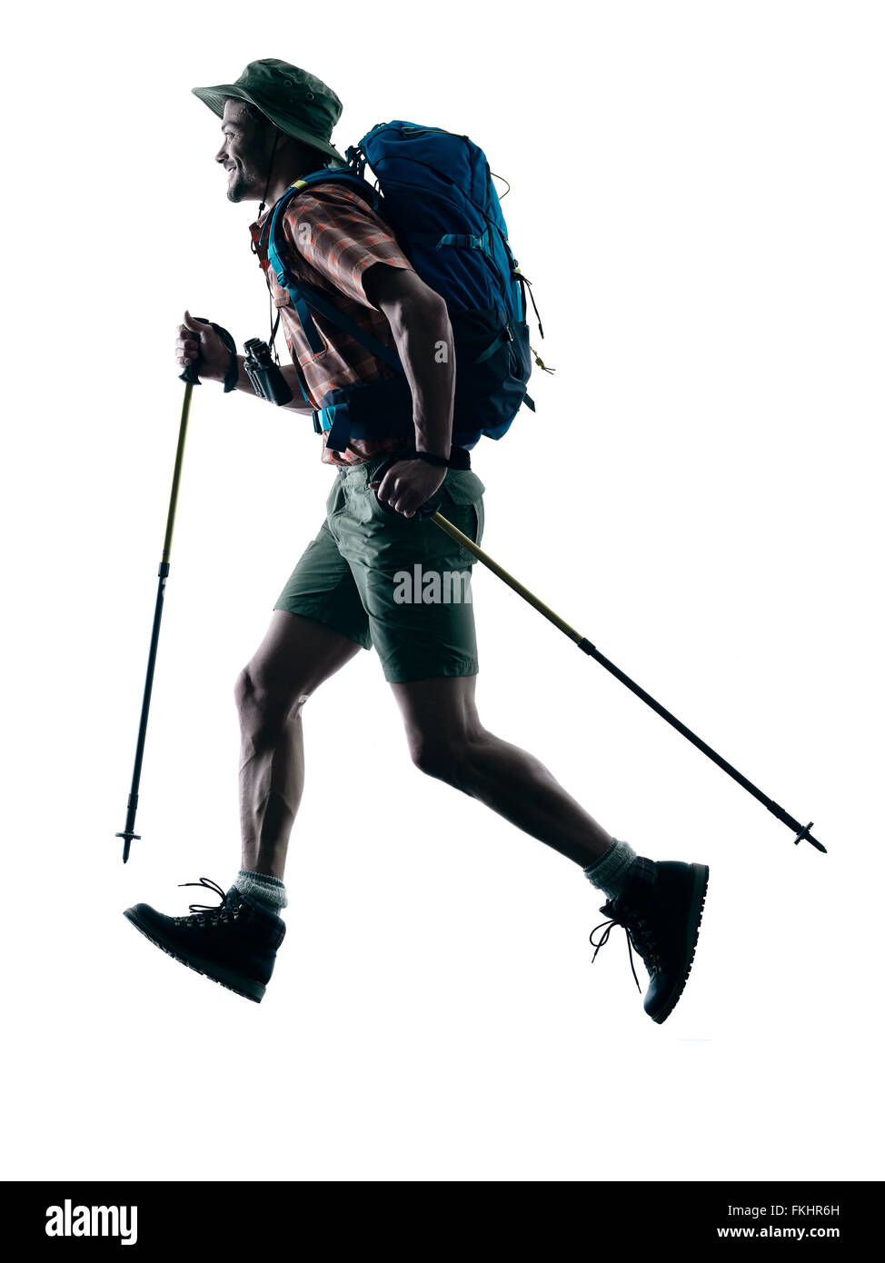 one caucasian man trekker trekking running happy  in silhouette isolated on white background Stock Photo