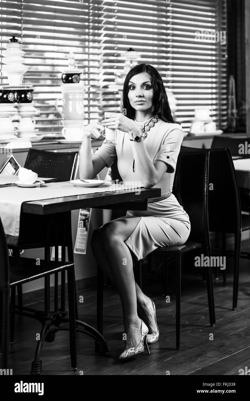 Beautiful young woman sitting in the cafe Stock Photo