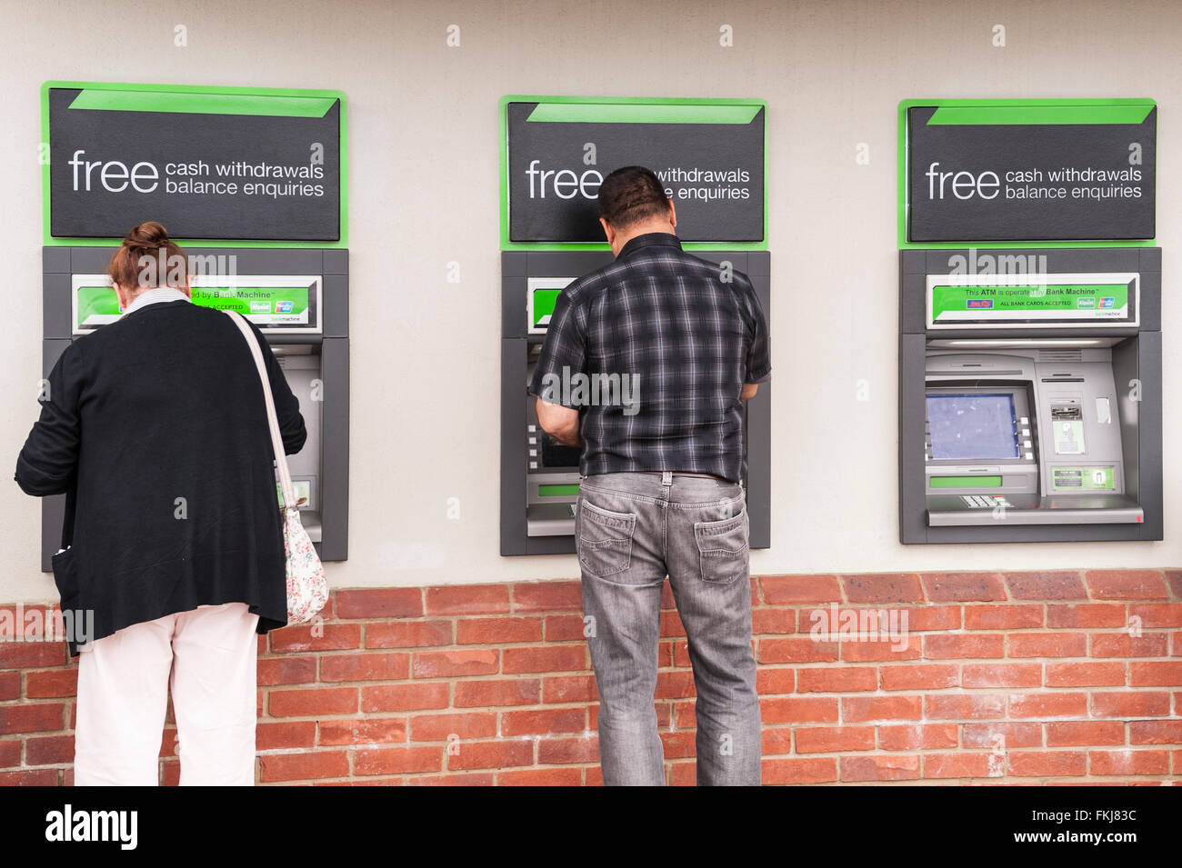 People using ATM cash machines in the Uk Stock Photo