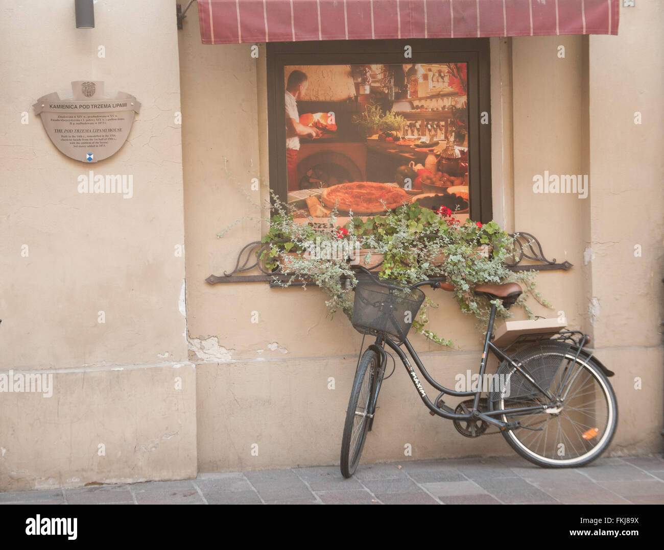 A bike propped up against an old shop, Krakow, Poland Stock Photo