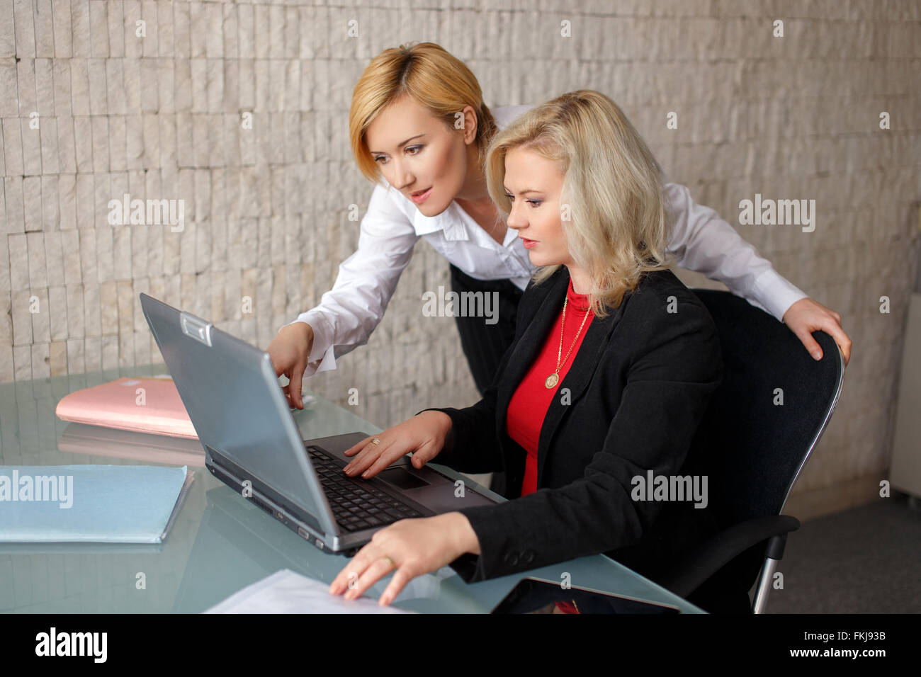 Two confident business ladies, work in office Stock Photo - Alamy
