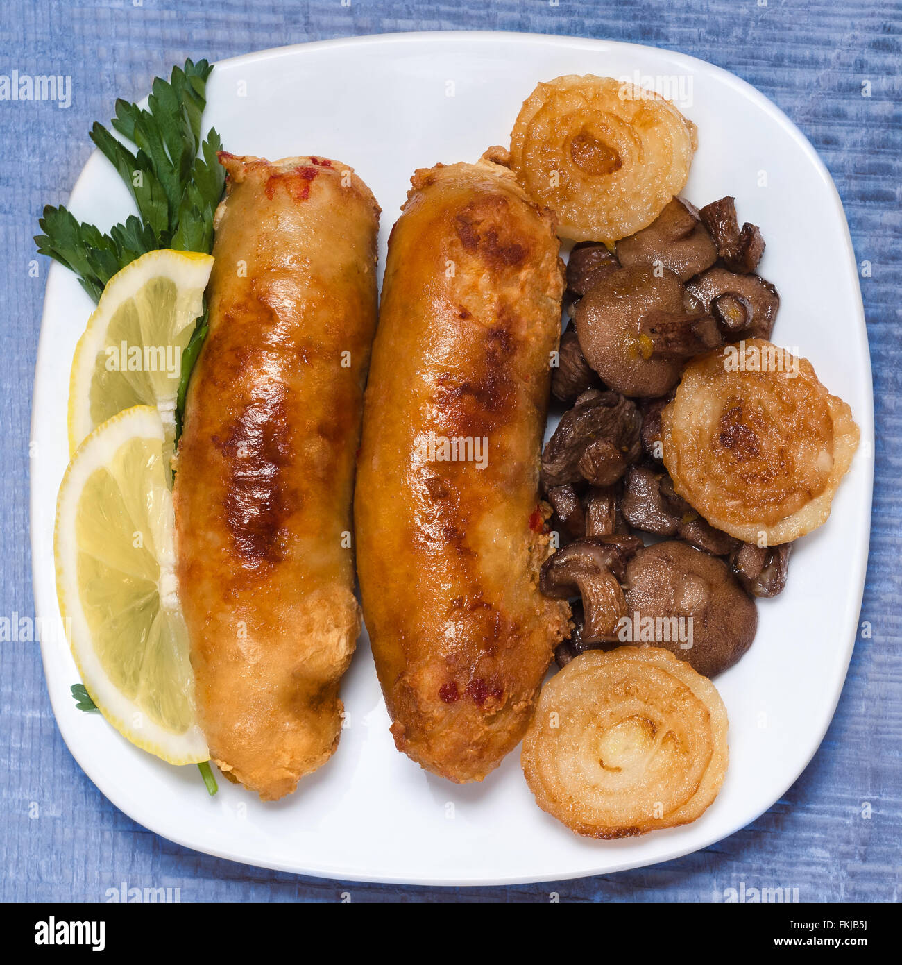 Fried sausage with mushrooms and onions. Stock Photo