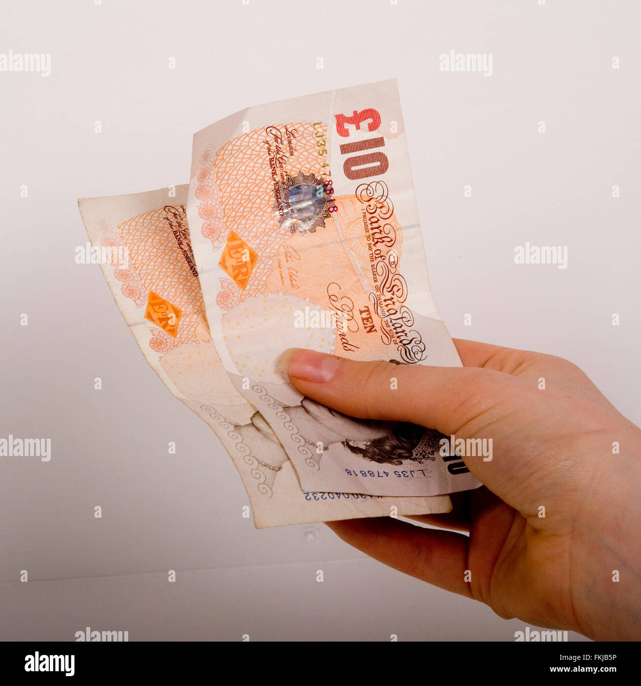 paying with cash, ten pound notes Stock Photo