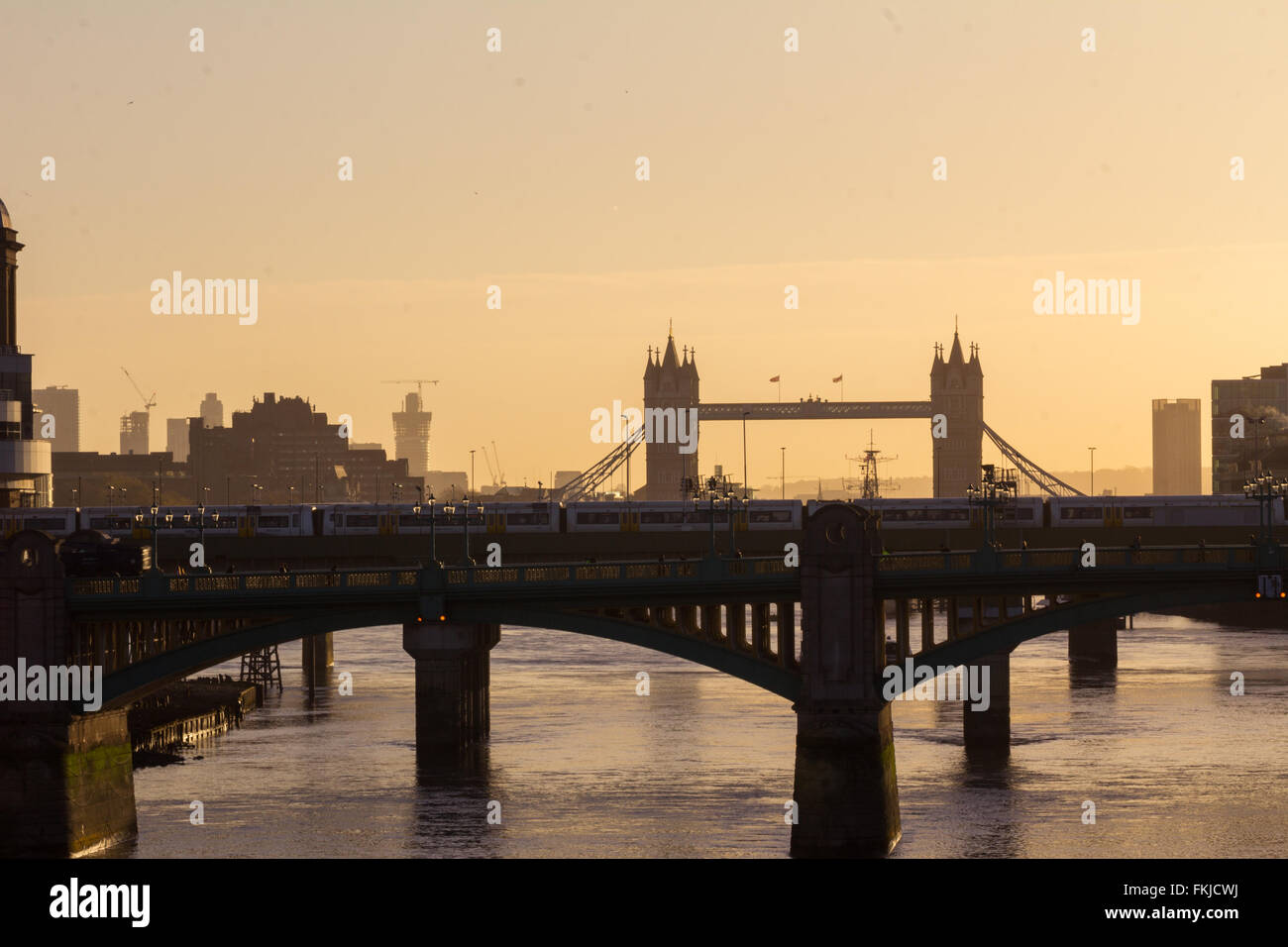 Southwark Bridge and Tower Bridge as viewed from the Millennium Bridge in the early morning London haze Stock Photo