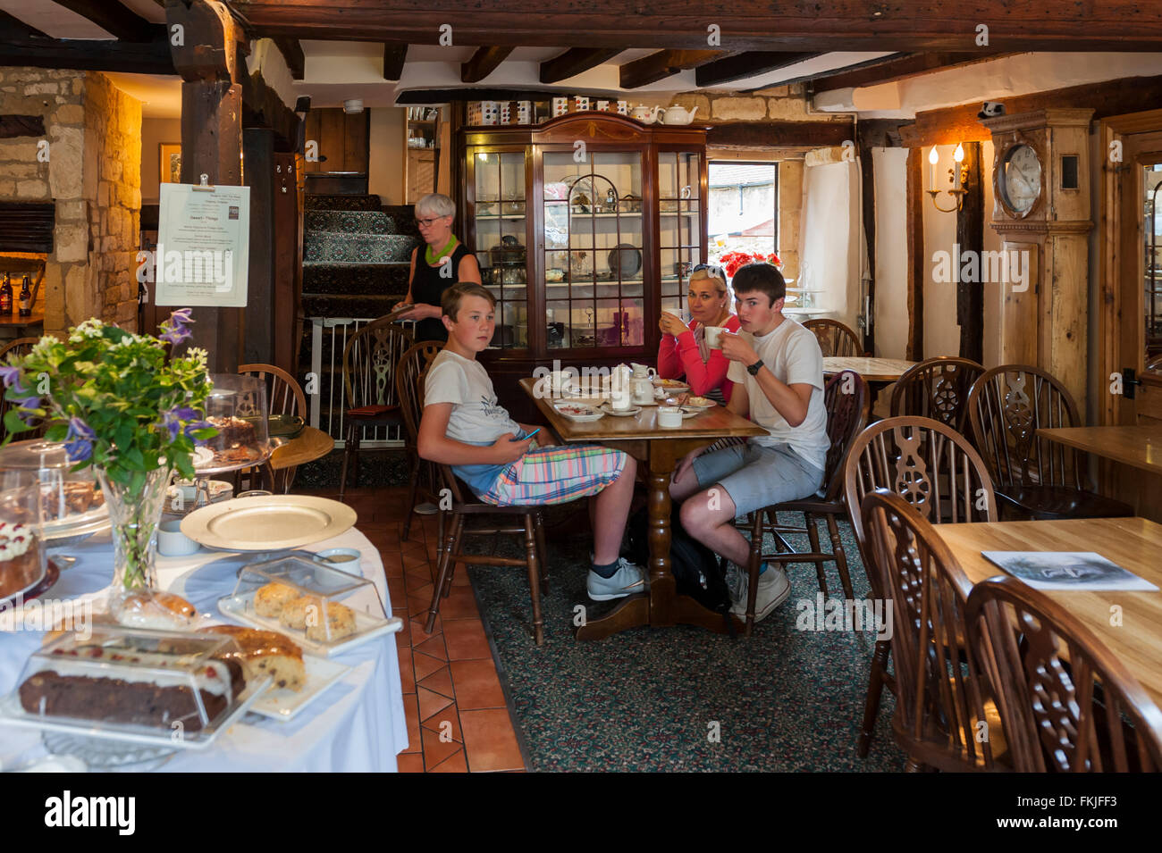 A mother and her 2 sons having afternoon tea in a Uk tearoom Stock Photo