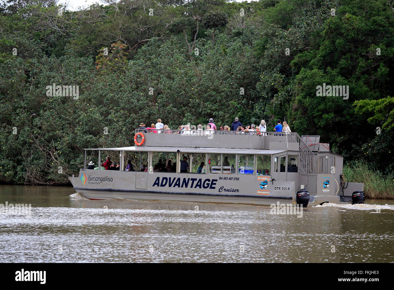 Excursion boat, tourists on boat safari, St Lucia, St Lucia Estuary, Isimangaliso Wetland Park, Kwazulu Natal, South Africa, Stock Photo