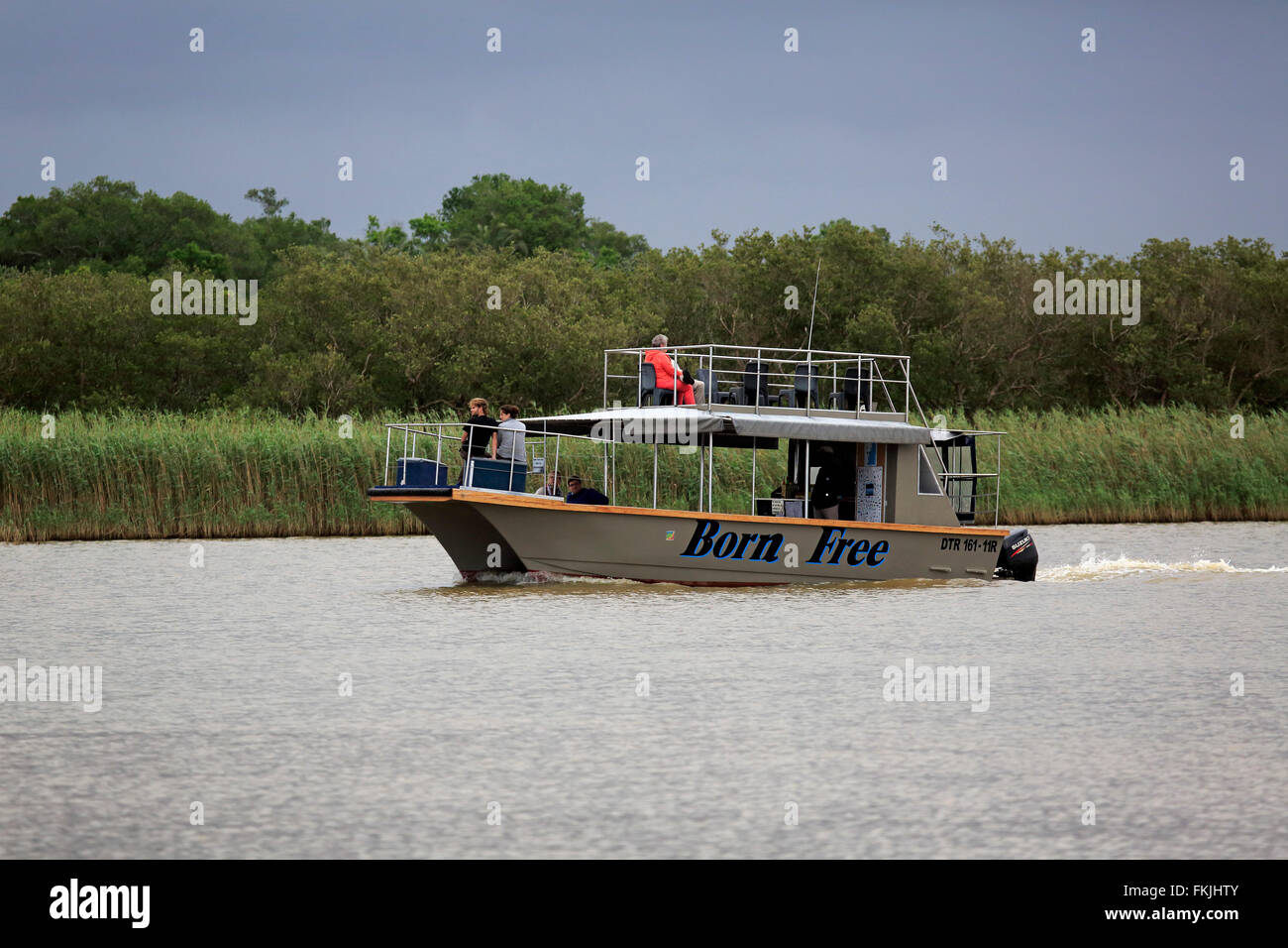 Excursion boat, tourists on boat safari, St Lucia, St Lucia Estuary, Isimangaliso Wetland Park, Kwazulu Natal, South Africa, Stock Photo