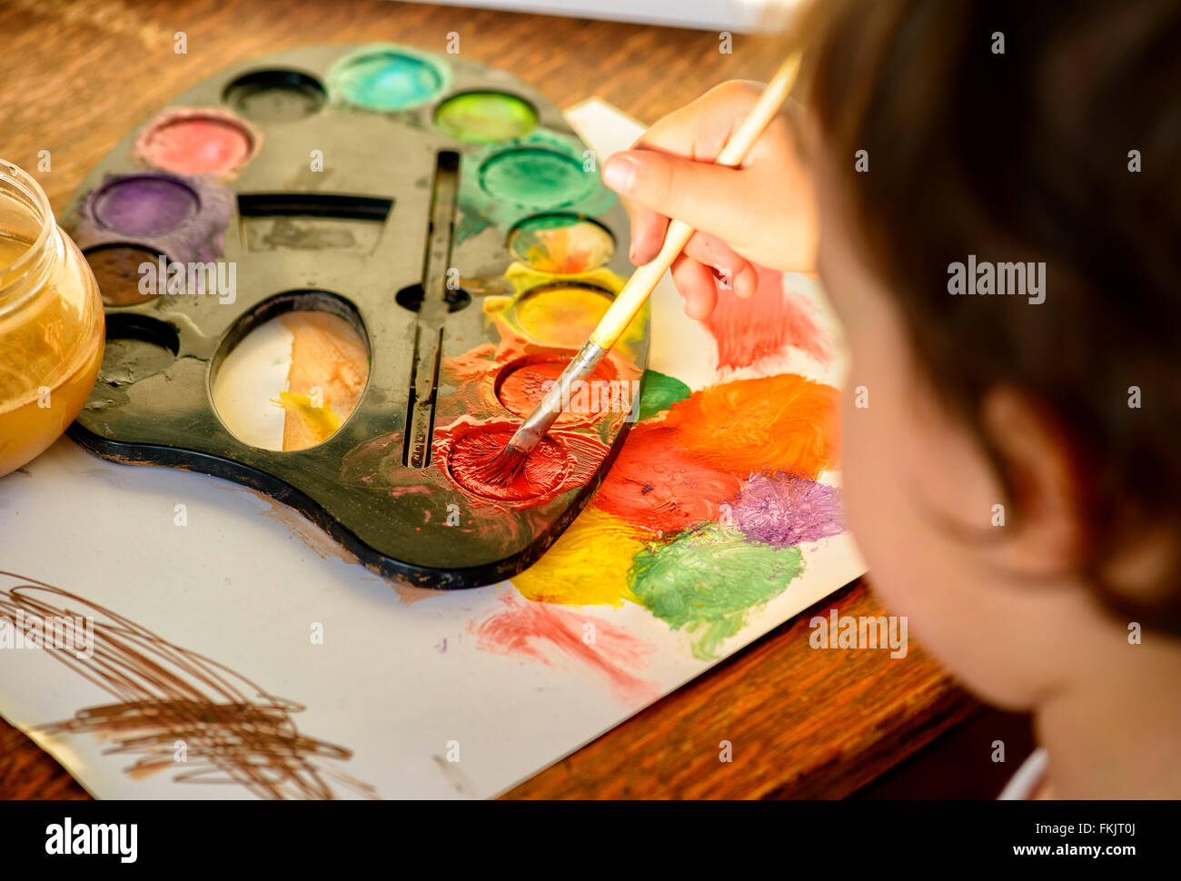 Little girl painting with water color - top view Stock Photo