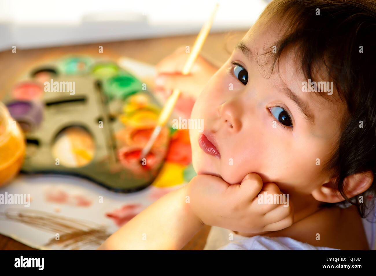 Little girl painting with water color - top view Stock Photo