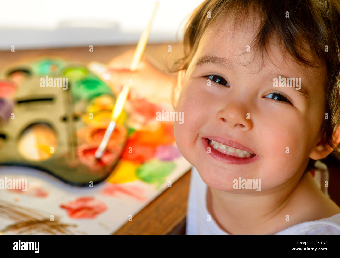 Little girl painting with water color - top view Stock Photo