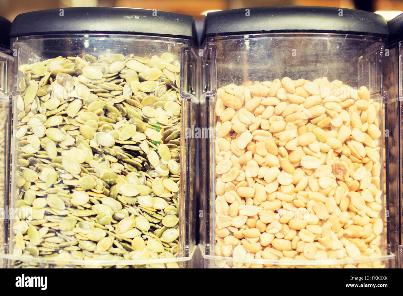 jars of peanuts and pumpkin seeds at grocery store Stock Photo Alamy