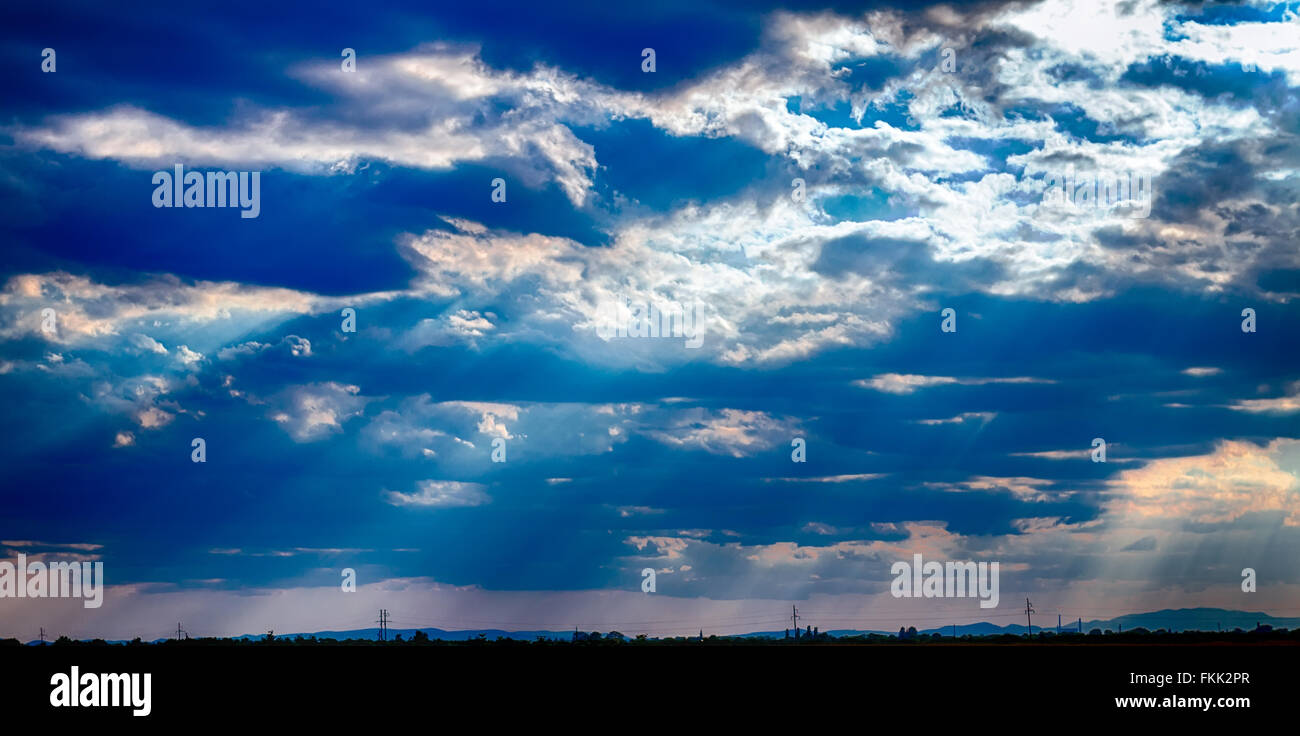 dramatic blue sky with clouds and sun rays Stock Photo - Alamy