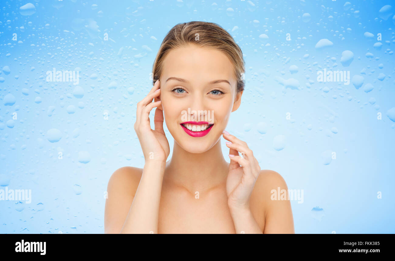 smiling young woman with pink lipstick on lips Stock Photo