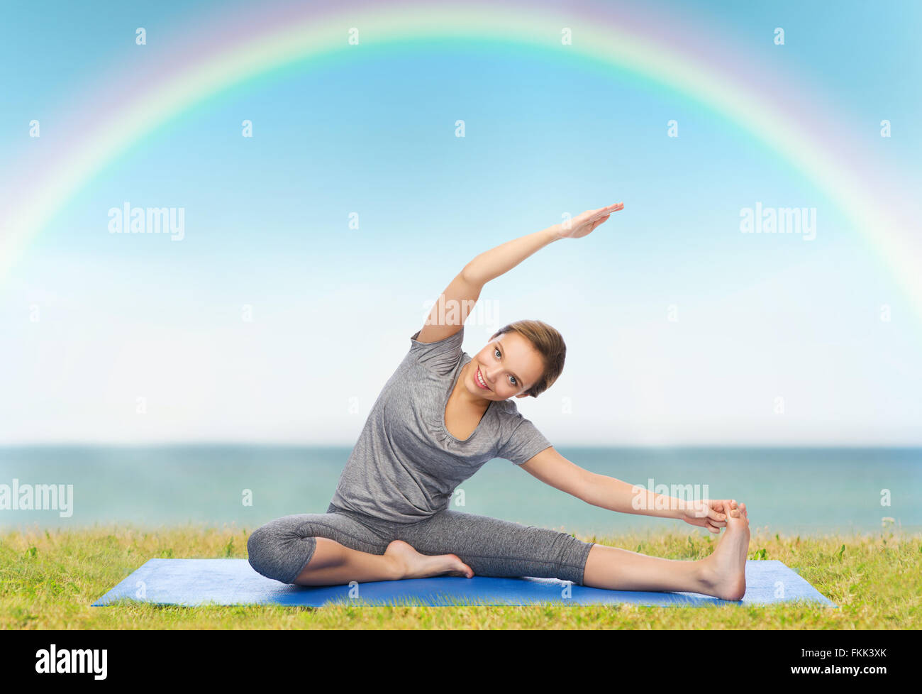 happy woman making yoga and stretching on mat Stock Photo - Alamy