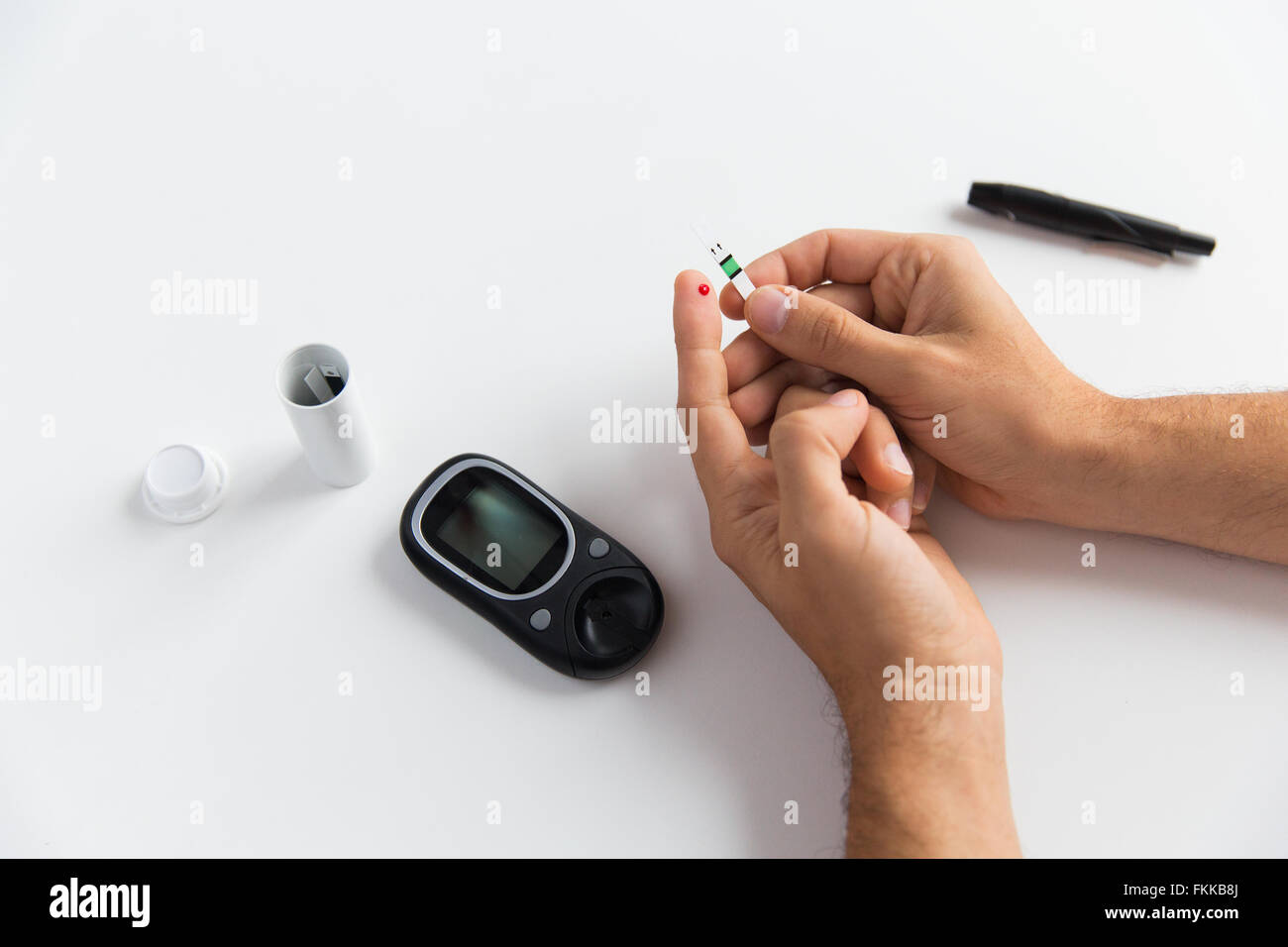 Man Using Glucometer close up of man checking blood sugar by glucometer Stock Photo - Alamy