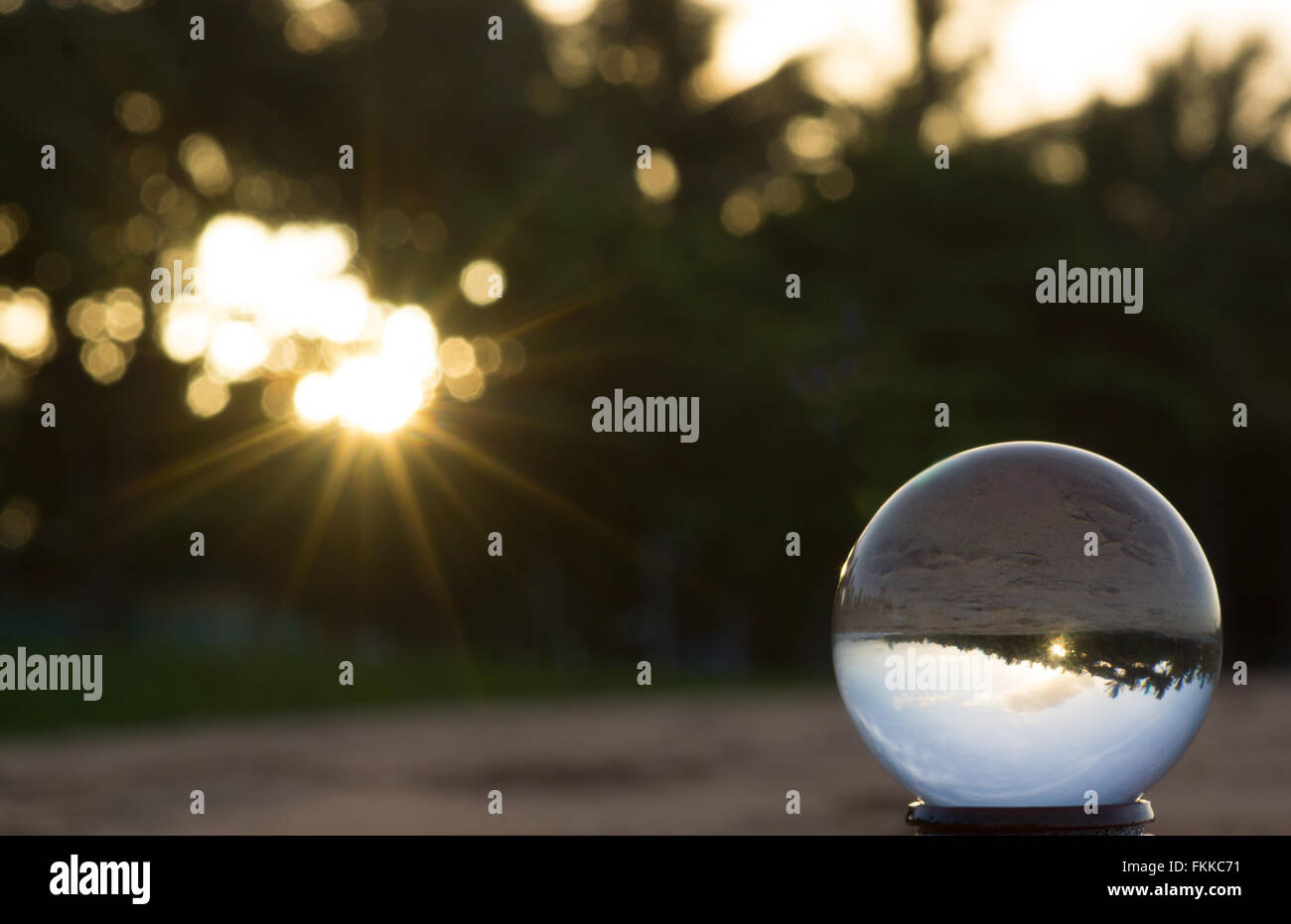 Crystal ball with sun flare and beach reflection of The Strand, Townsville, Australia Stock Photo