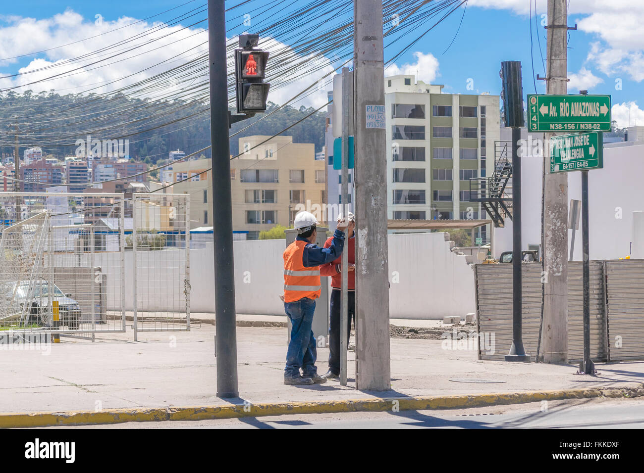 QUITO, ECUADOR, OCTOBER - 2015 - Urban scene of two construction workers talking in outskirts district of Quito city, the capita Stock Photo