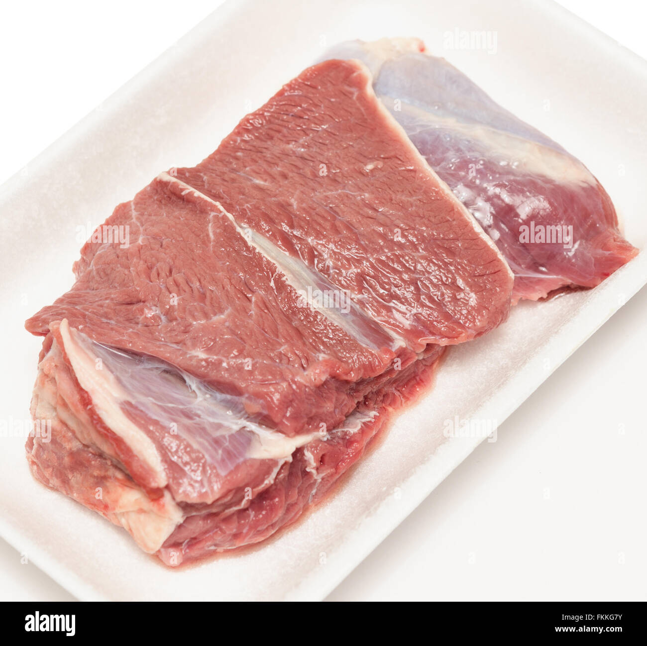 raw meat in plastic tray isolated on white background Stock Photo Alamy