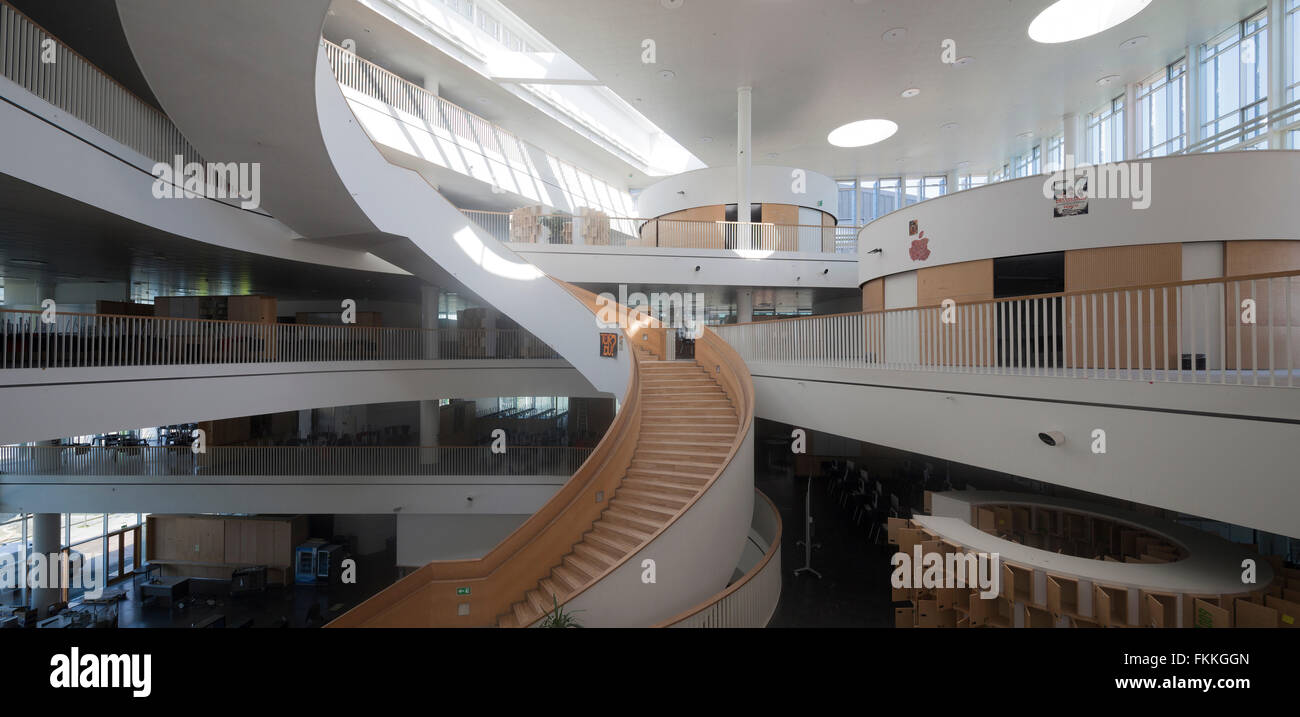 An interior view of the large spiral stairs in Orestad College, a modern place of learning. Stock Photo