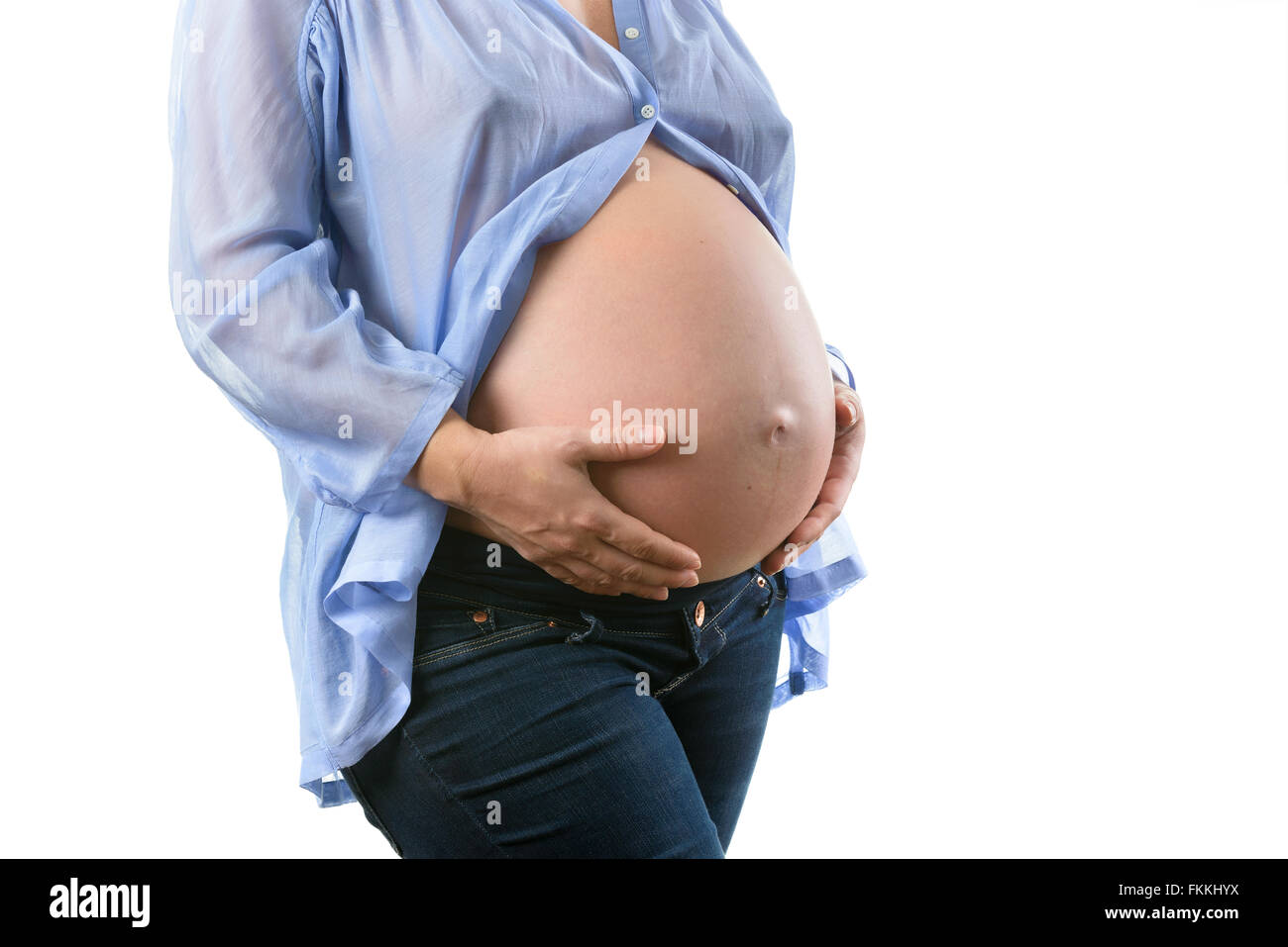 Pregnant woman belly blue shirt Stock Photo