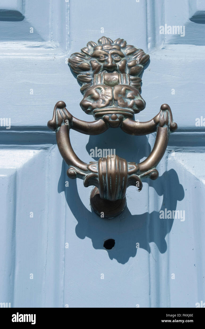 A door knocker on a white door, of a residential house. Stock Photo