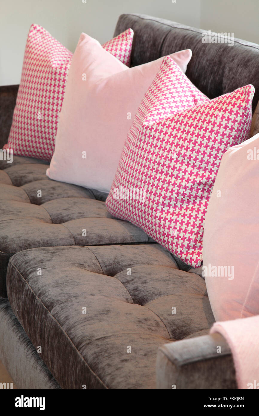 A grey sofa, with pink cushions Stock Photo - Alamy