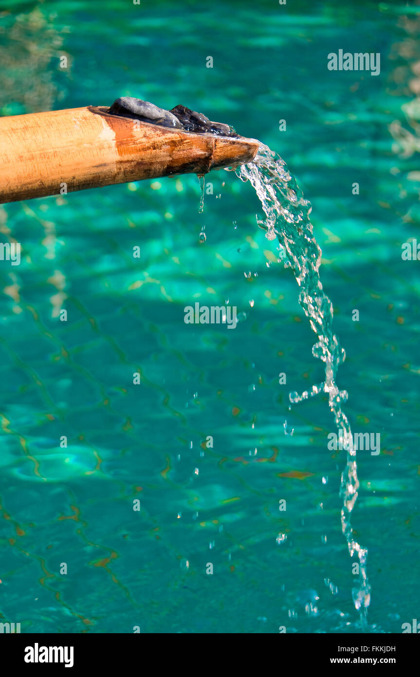 Bamboo fountain and water, aqua background Stock Photo