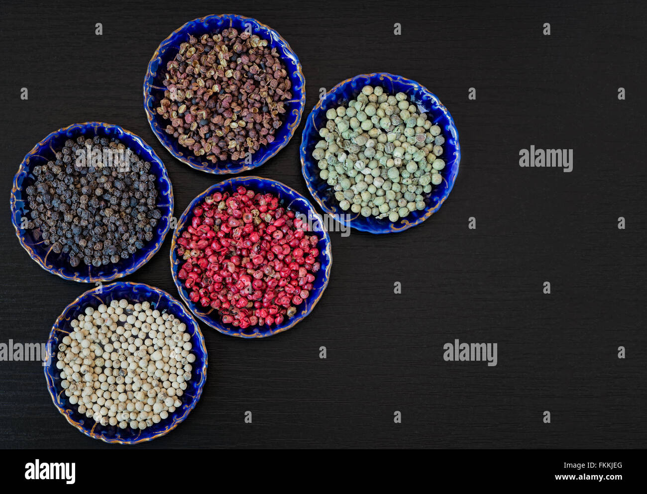 Sichuan, white, red, green, black peppercorns in blue vintage ceramic