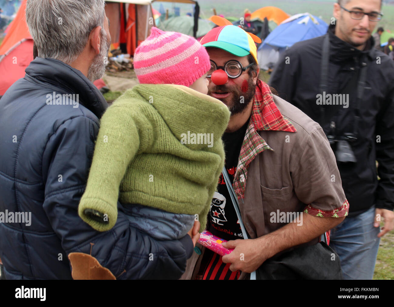 Idomeni, Greece. 9th Mar, 2016. A member of the group 'Rebel Clowns' speaking with children in the refugee camp at the Greek-Macedonian border in Idomeni, Greece, 9 March 2016. Photo: Gregor Mayer/dpa/Alamy Live News Stock Photo