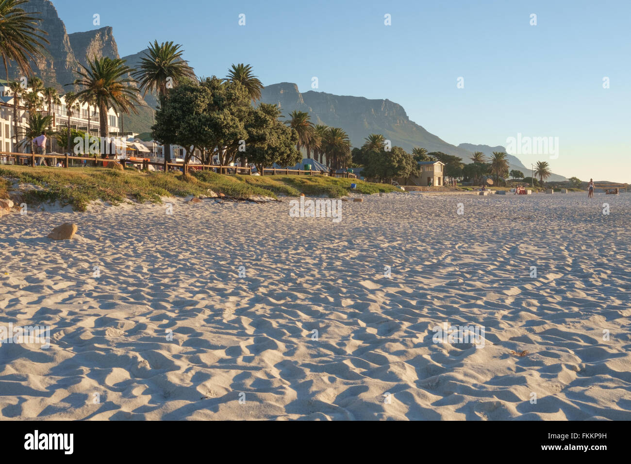 Sunset over Camps Bay beach, South Africa, with the twelve apostles mountains in the background Stock Photo