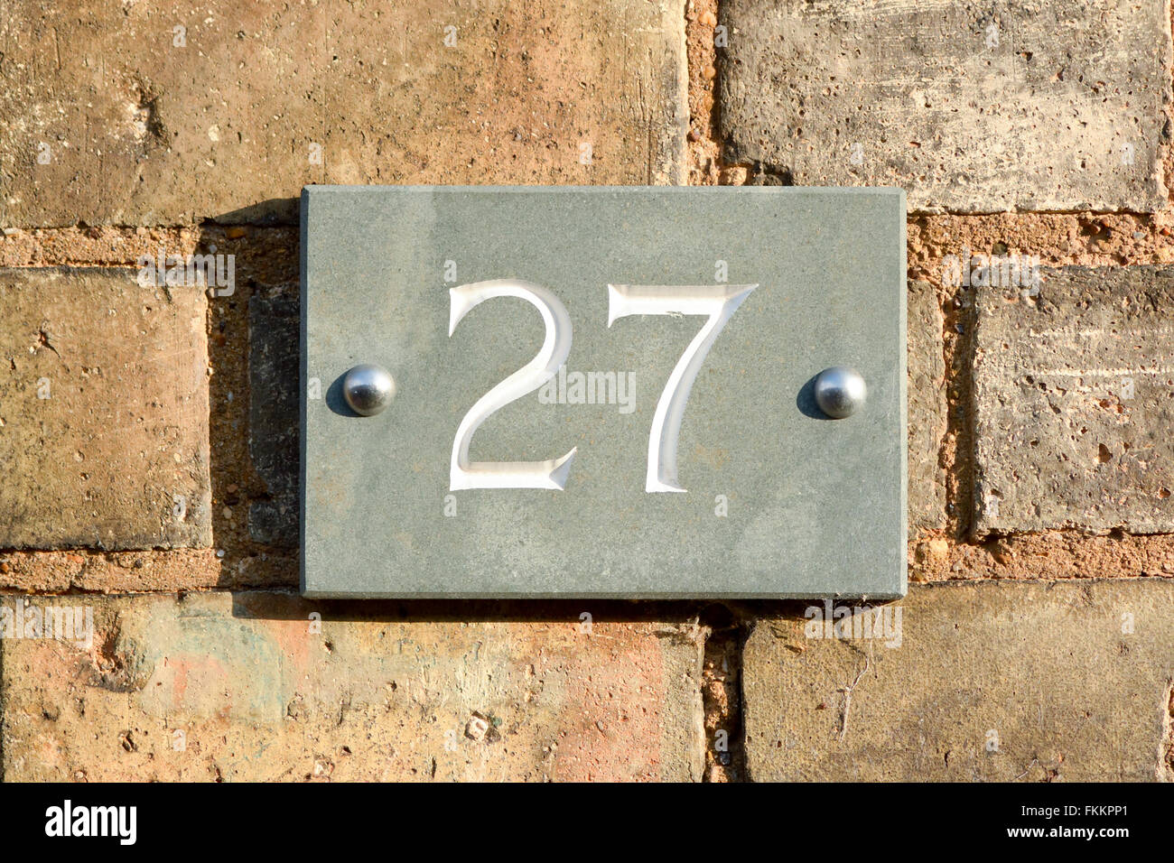 House number 27 sign on wall Stock Photo Alamy
