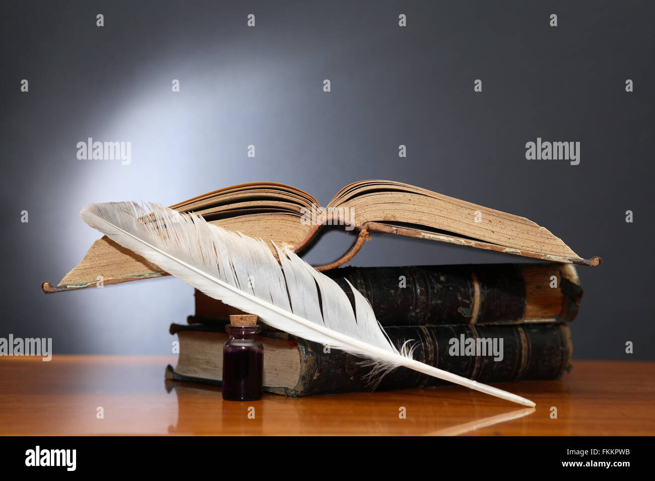 Literature concept. Still life with quill pen near book on wooden table Stock Photo Alamy