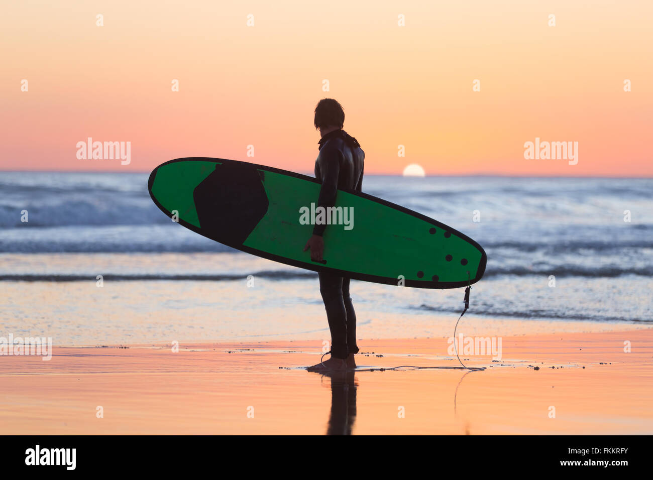 Silhouette of surfer on beach with surfboard Stock Photo - Alamy